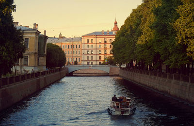Bridge over river amidst buildings in city