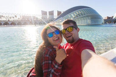 Portrait of smiling young woman in city