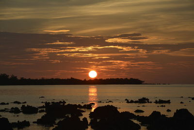 Scenic view of sea against romantic sky at sunset