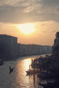 Sunset over river with buildings in background