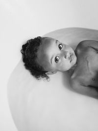 High angle portrait of child in bathtub