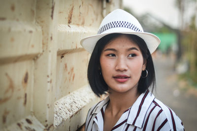 Teenage girl wearing hat while looking away