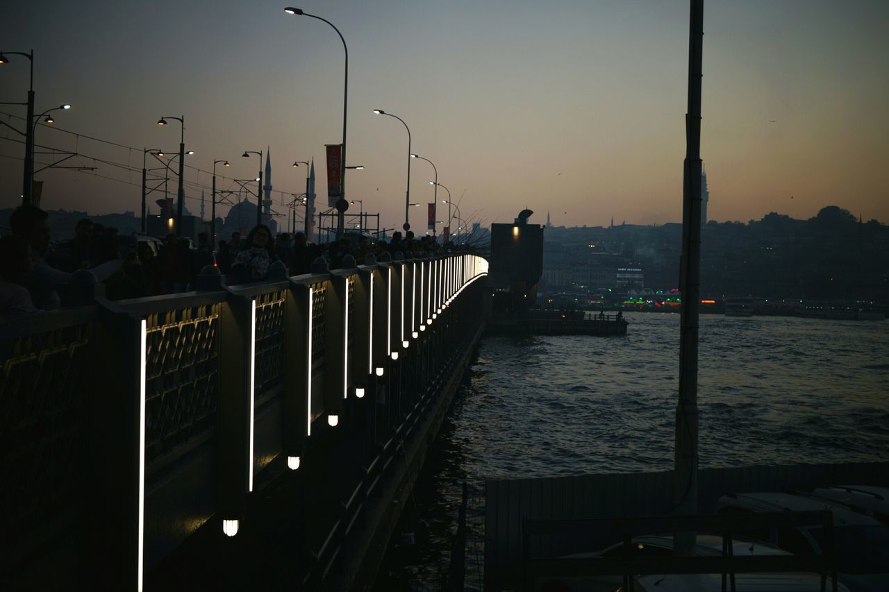 water, sunset, sea, railing, street light, silhouette, sky, built structure, dusk, pier, connection, nature, tranquility, tranquil scene, illuminated, scenics, clear sky, architecture, beauty in nature, lighting equipment