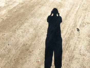 Shadow of woman on beach