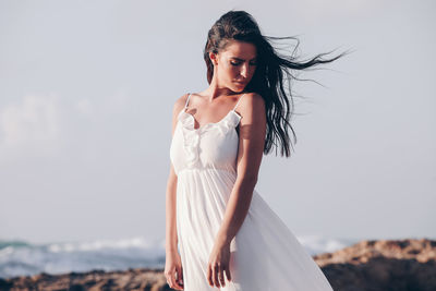 Portrait of beautiful woman against sky