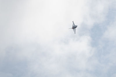 Low angle view of airplane flying in sky