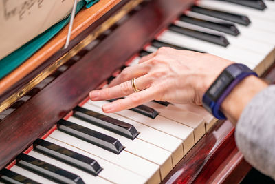 Midsection of man playing piano