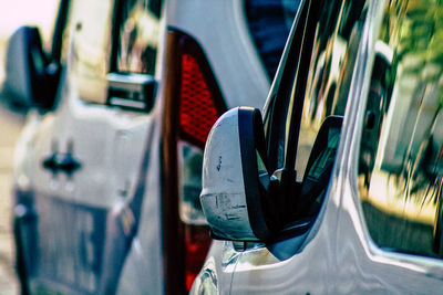 Close-up of car parked in row