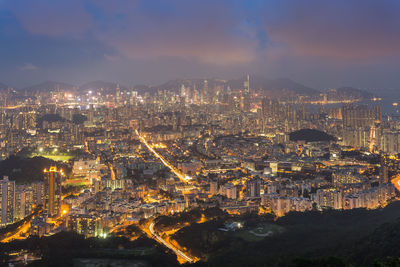 Illuminated cityscape against sky at night