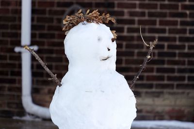 Close-up of angel statue against snow