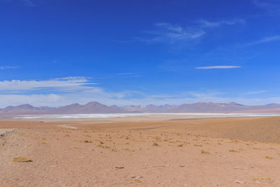 Scenic view of desert against blue sky