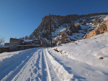 Snow covered mountain against clear blue sky