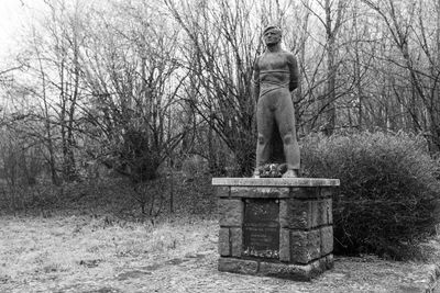 Statue against clear sky at cemetery
