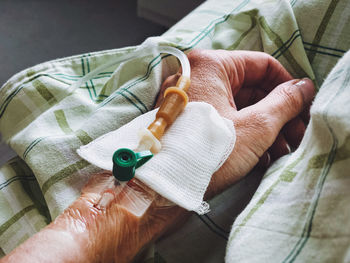 Woman's hand with a catheter in his vein