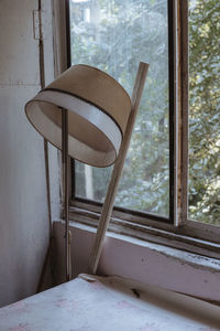 Vintage floor lamp and table against window