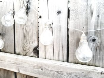 Close-up of light bulb hanging on table