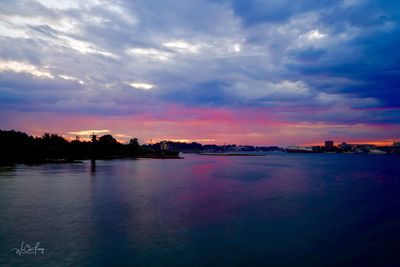 Scenic view of sea against dramatic sky during sunset