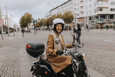 Smiling woman on scooter