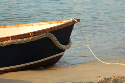 Close-up of rope tied to boat moored in sea