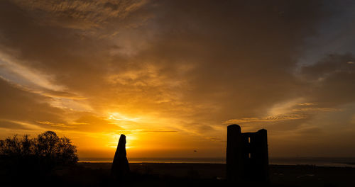 Silhouette building against sky during sunset