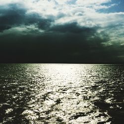 Scenic view of sea against cloudy sky