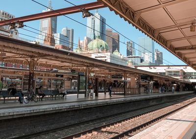 Train at railroad station against clear sky