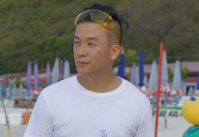 Thoughtful man standing at beach