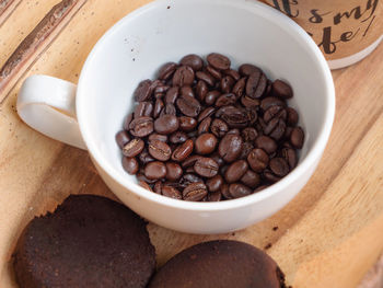 High angle view of coffee beans in bowl on table