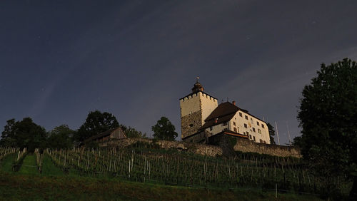 Low angle view of abandoned building against sky at night