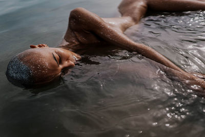 Young bald girl on the beach