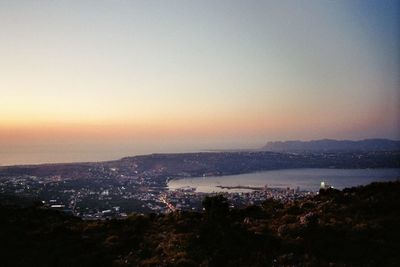 Scenic view of cityscape against sky during sunset