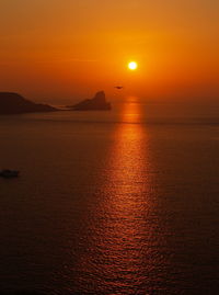 Scenic view of sea against orange sky