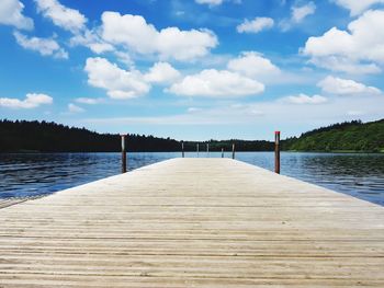 Pier over lake against sky