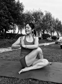 Woman meditating while sitting in park