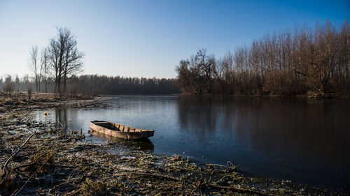 Scenic view of lake against sky during winter