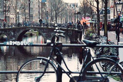 Bridge over canal by city buildings