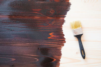 High angle view of brush on wooden table