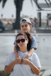 Portrait of mother and son at harbor