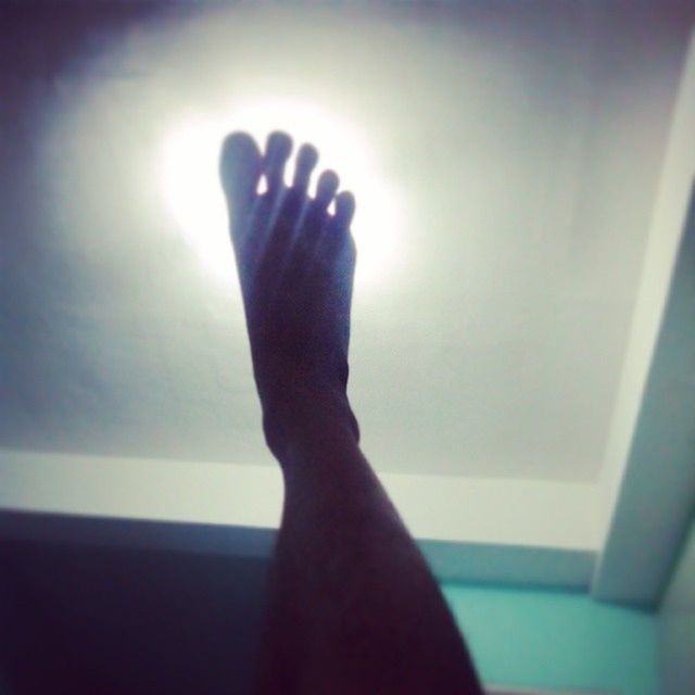 indoors, person, personal perspective, part of, sunlight, lifestyles, home interior, low section, human finger, unrecognizable person, leisure activity, cropped, domestic room, wall - building feature, human foot