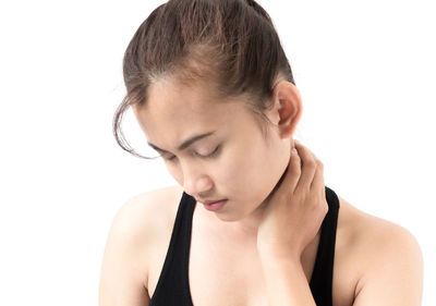 Close-up of young woman against white background