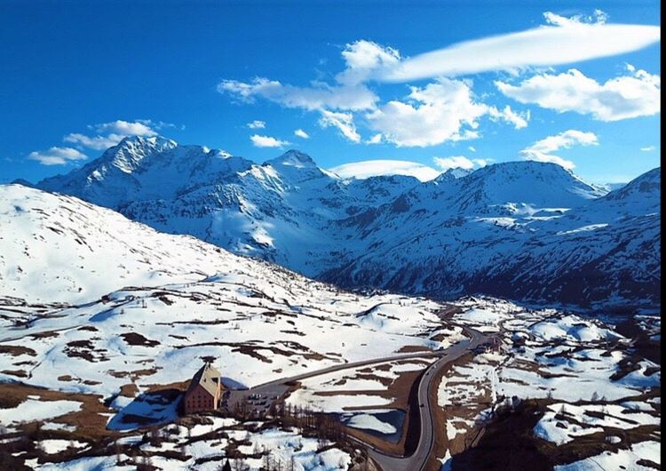 SNOW COVERED MOUNTAINS AGAINST SKY