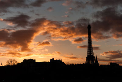 Low angle view of silhouette tower during sunset