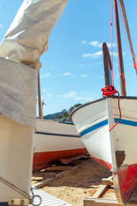 Close-up of ship moored at sea against sky