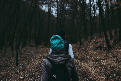 Rear view of man and woman in forest