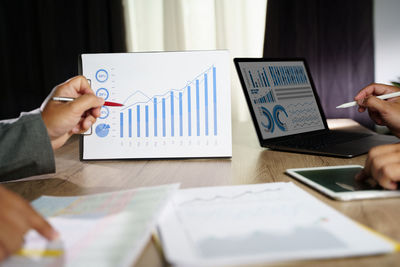 Midsection of businessman working on table