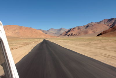 Scenic view of mountain road against cloudy sky
