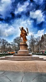 Low angle view of statue against cloudy sky