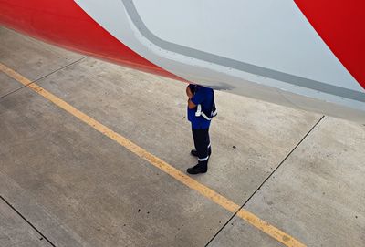 Full length of woman standing by railing