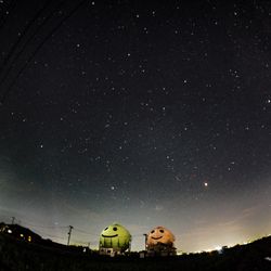Low angle view of illuminated building against sky at night