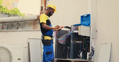 Side view of man working at construction site